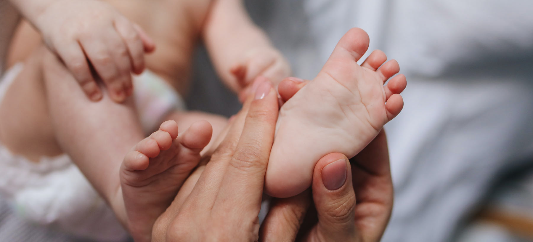 baby feet in adult hands