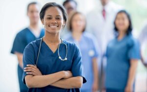 young female nurse standing in front of her colleagues