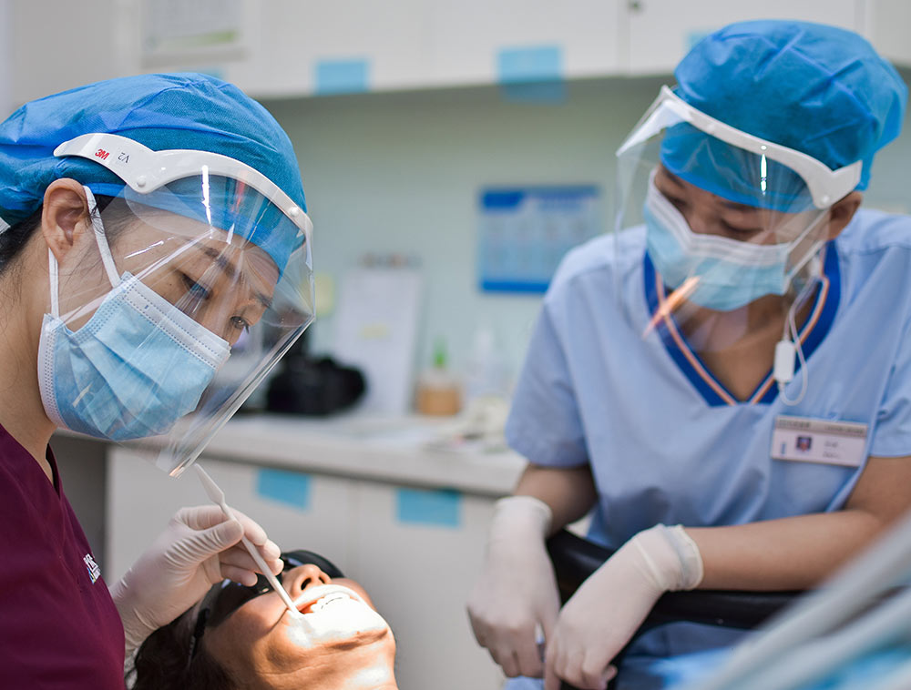 dental assistant aiding in patient procedure